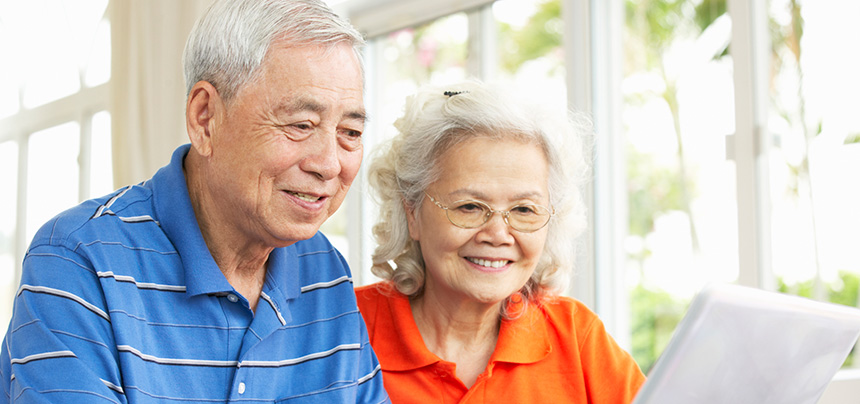 Elderly couple reading a stack of papers