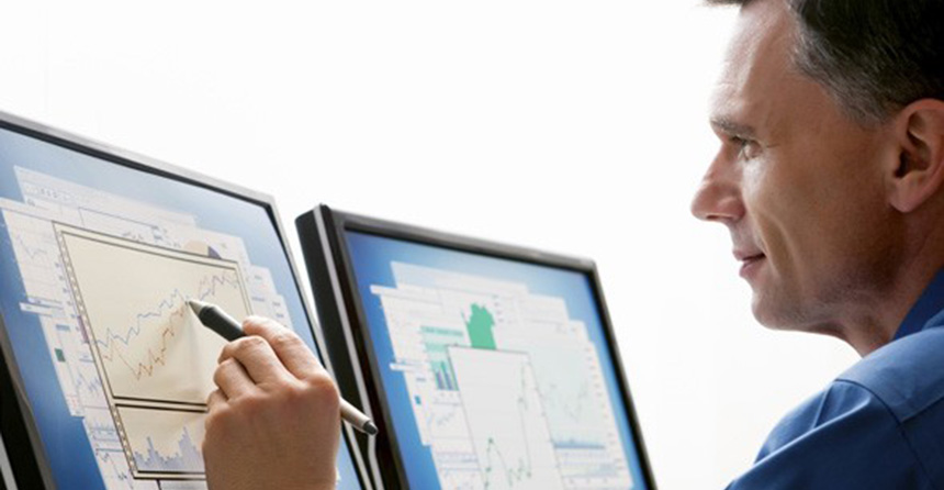 Man studying a graph on a computer monitor with a stylus