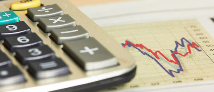 Close-up of a calculator on top of a line graph