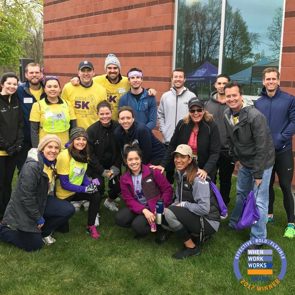 Group of men and women posing for a picture at a 5K fundraising event