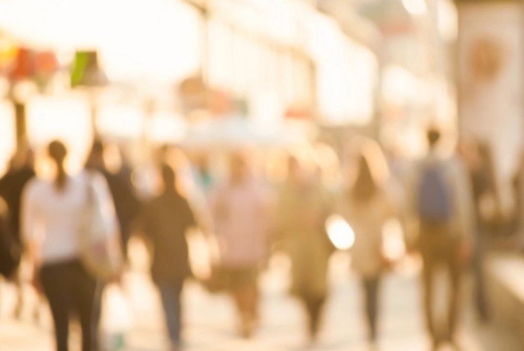 An unfocused image of people walking away from the camera