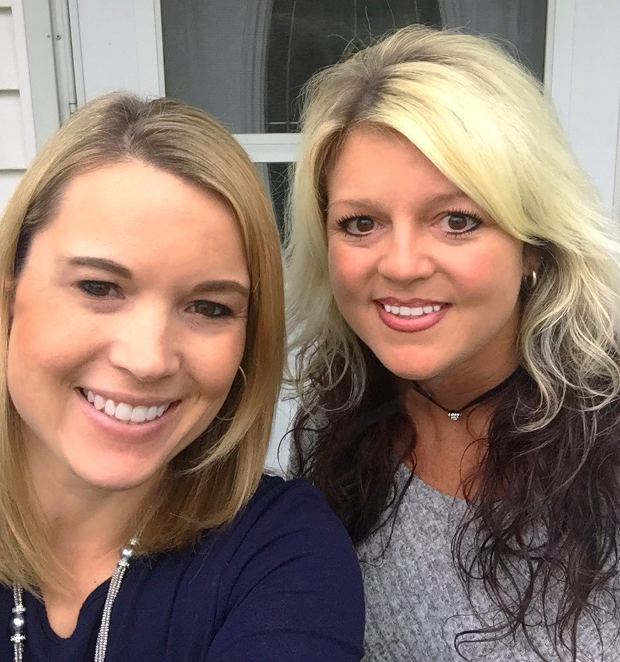 Two women smiling and posing for a selfie