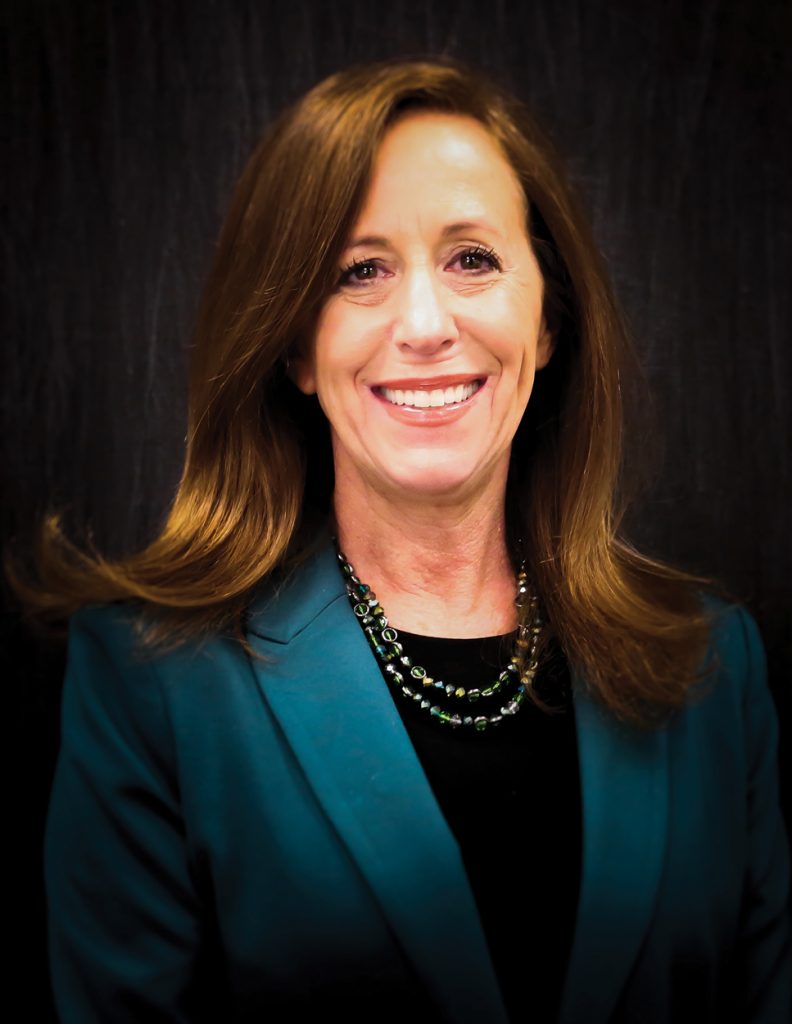 A smiling woman posing for a professional photo