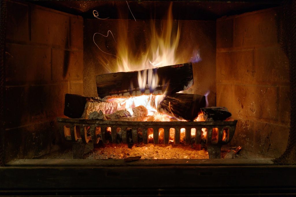 A roaring fire in a fireplace