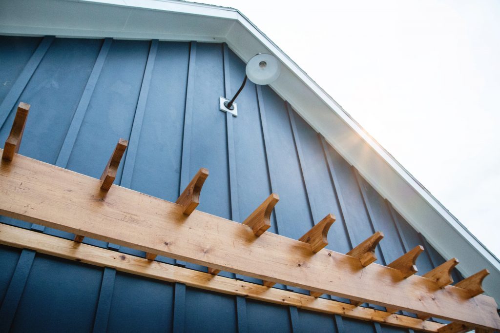 An upward angled shot at the white eave of a blue house