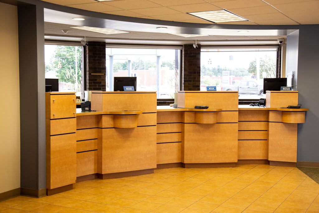 A Consumers Credit Union office location curved front desk with three bank teller windows