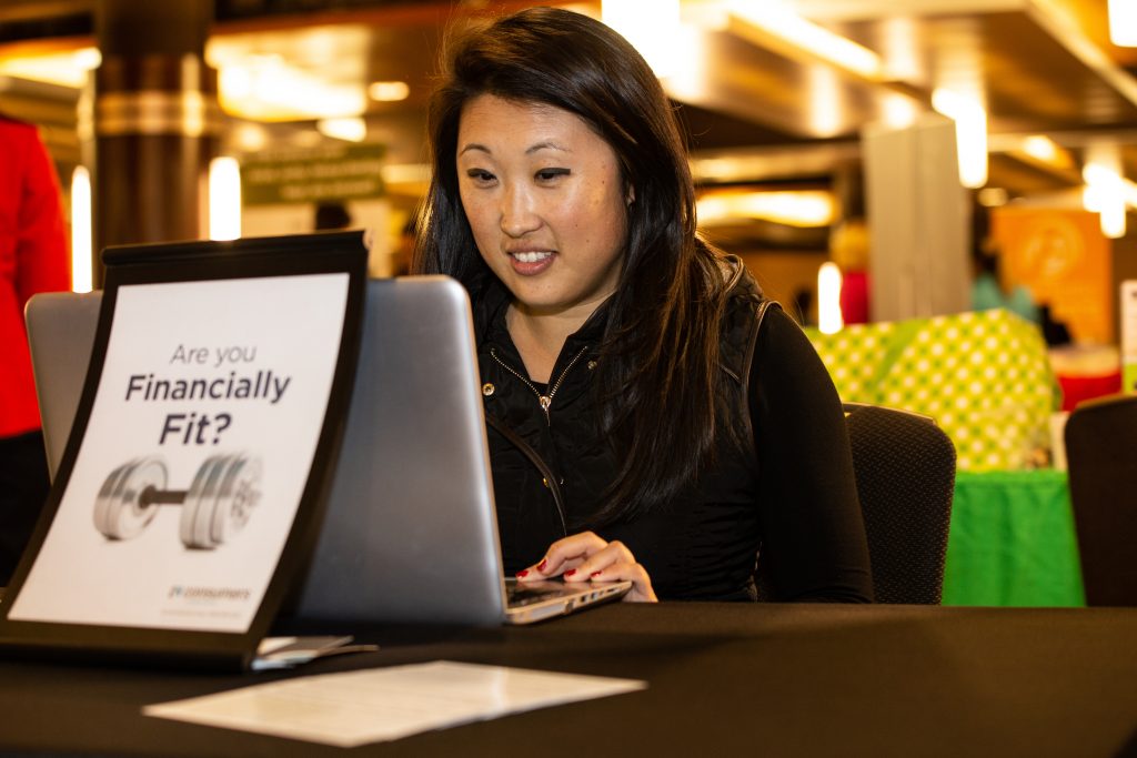 A woman on a laptop with a picture of a dumbell with the words, 