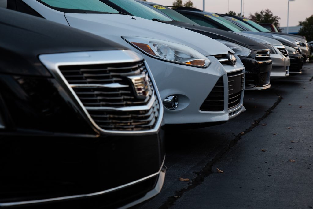 A row of cars in a parking lot