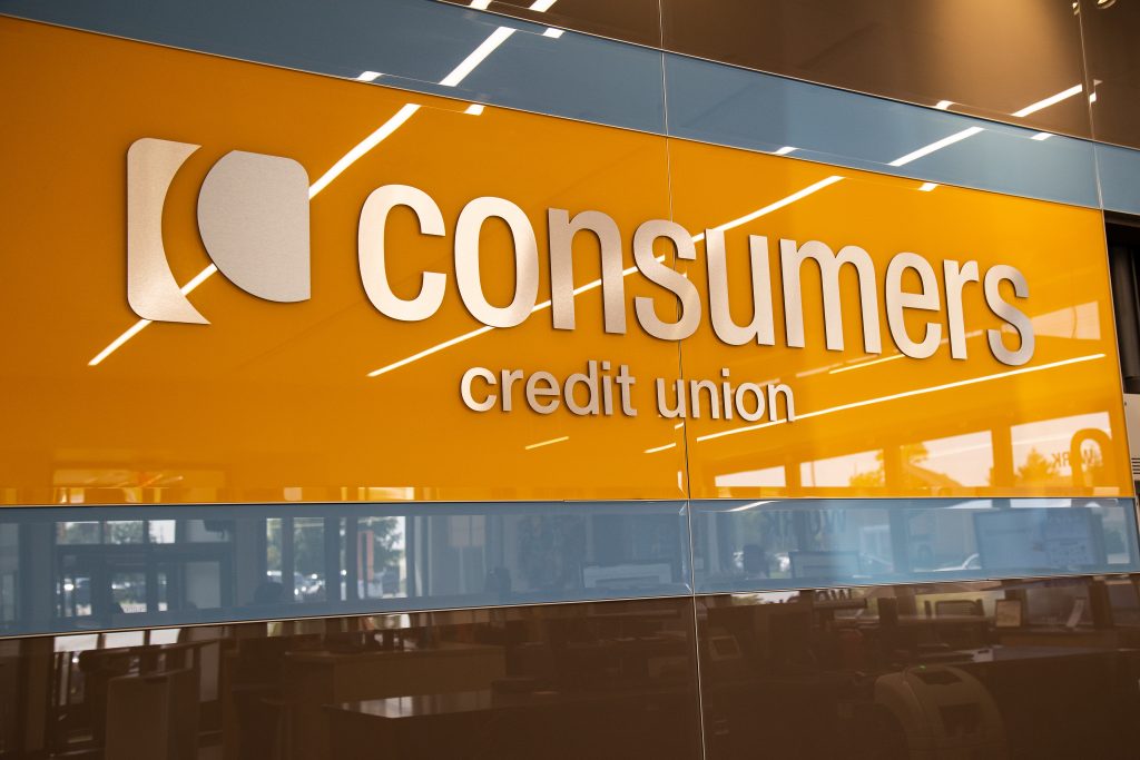 A close-up of an orange Consumers Credit Union sign