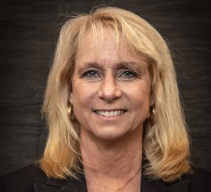 A blonde woman smiling in a headshot