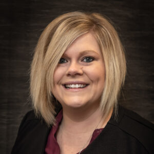 A blonde woman smiling in a professional headshot