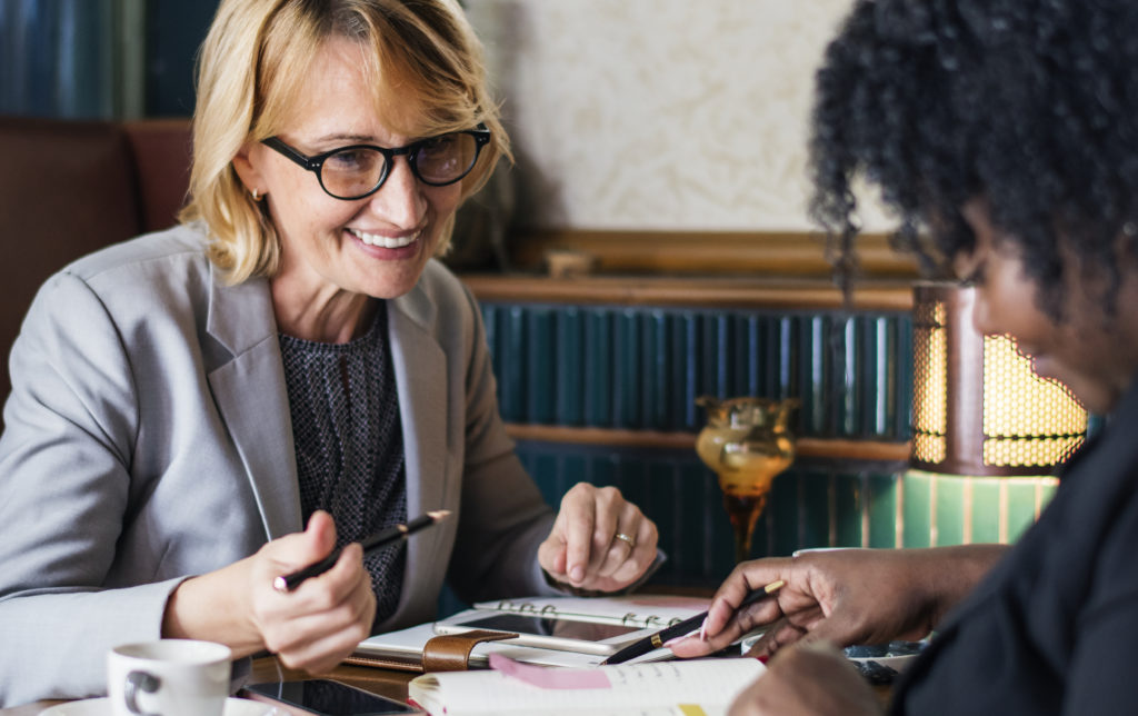 Women meeting with female lawyer in office