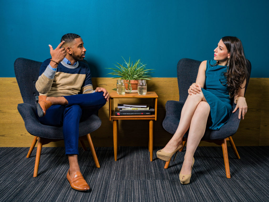 Man and woman sitting in chairs talking