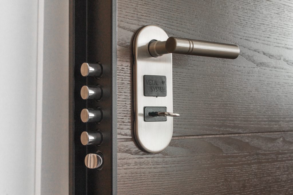 Closeup of a door showing the handle, keyhold and deadbolts