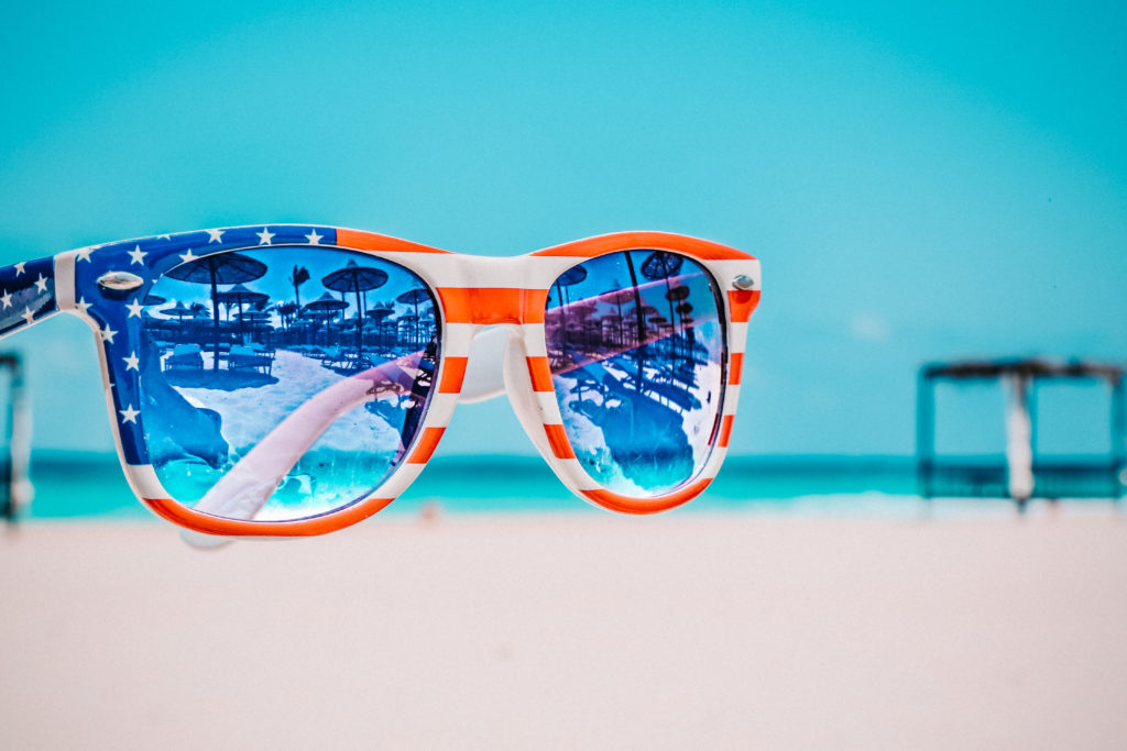 American flag sunglasses with sea in the background