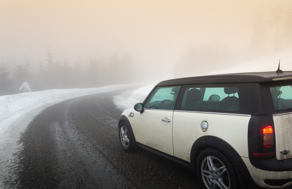 a car drives down a slushy road