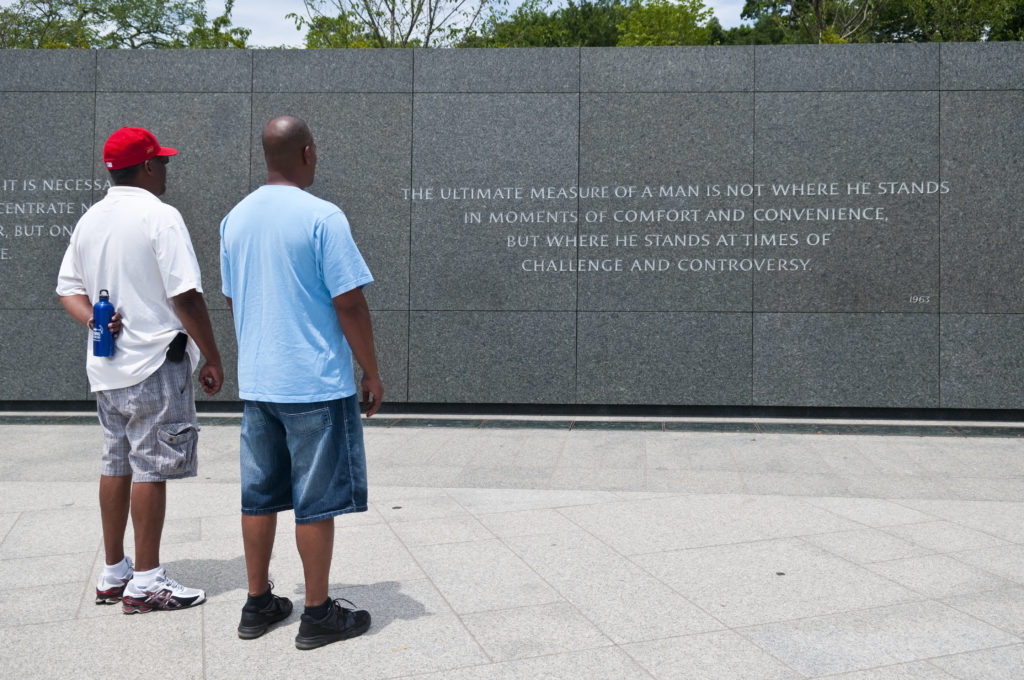 An African-American father and son stand together at the Martin Luther King Jr. Memorial