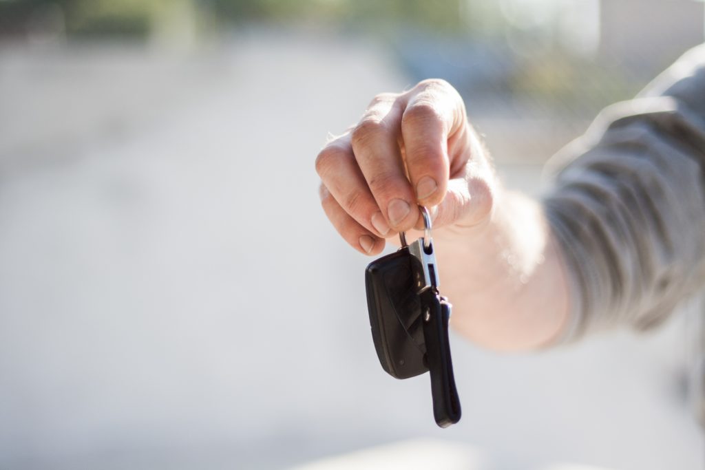 Hand holding up car keys