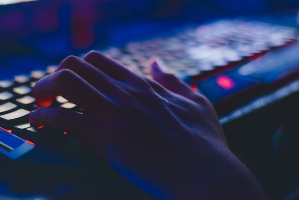 Hands typing on a computer keyboard