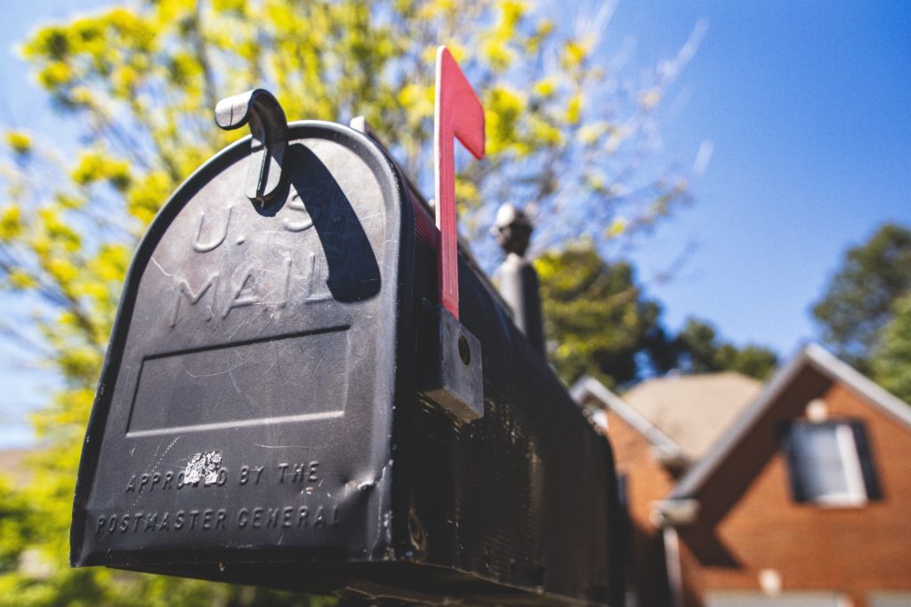 Up close of black mailbox with red flag